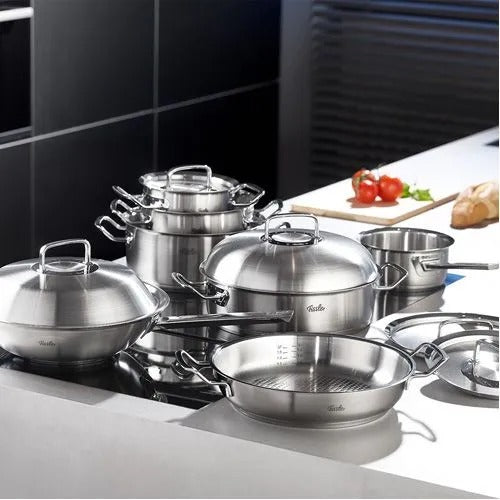 Set of stainless steel cookware on a kitchen counter