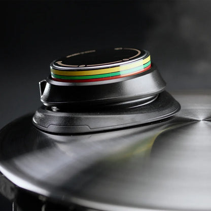 Close-up of a black electronic device with colorful stripes on a reflective surface