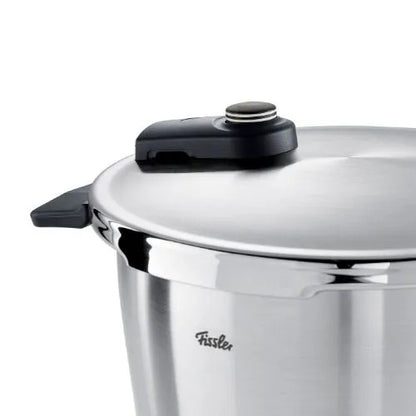 Stainless steel pressure cooker with black lid knob on a white background