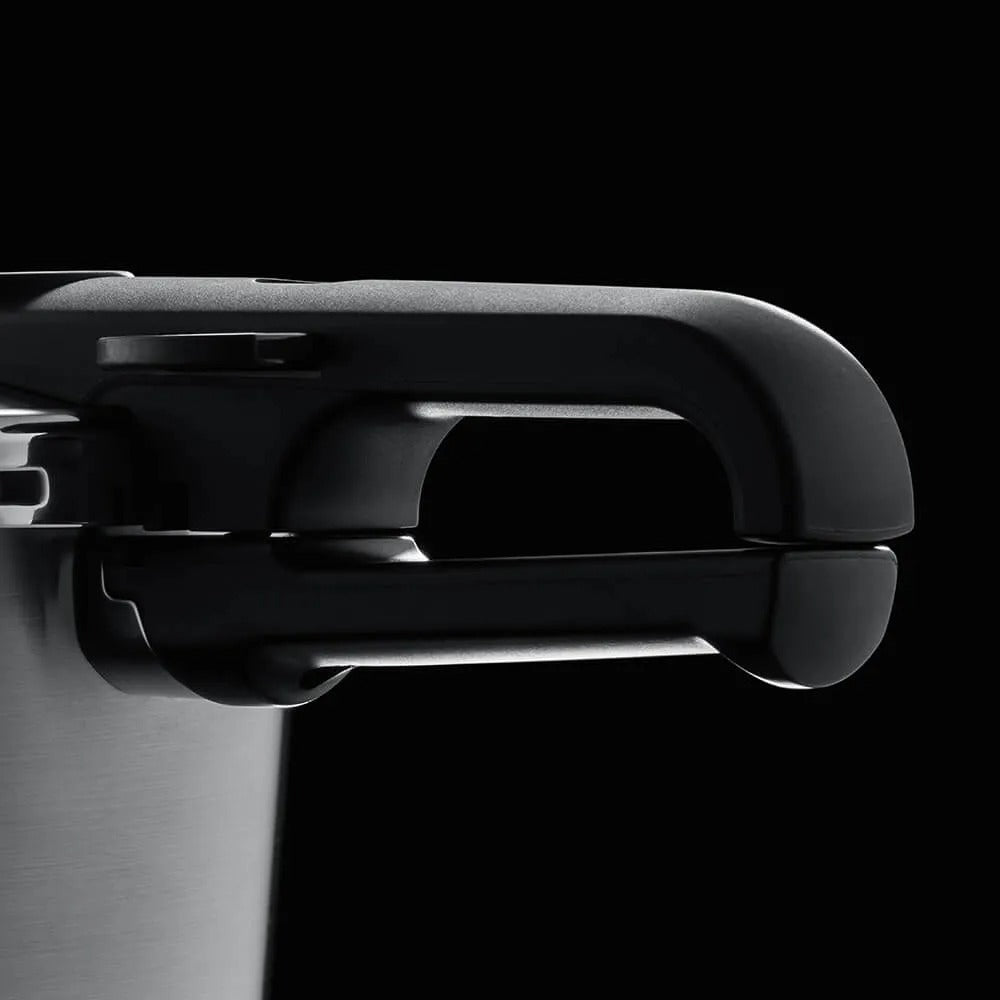 Close-up of a pressure cooker lid handle on a black background