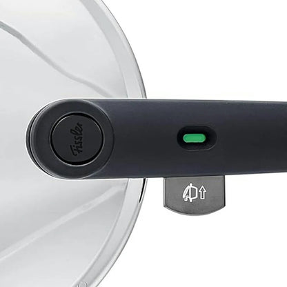 Close-up of a black lid lock mechanism on a white lid with a green light indicator.